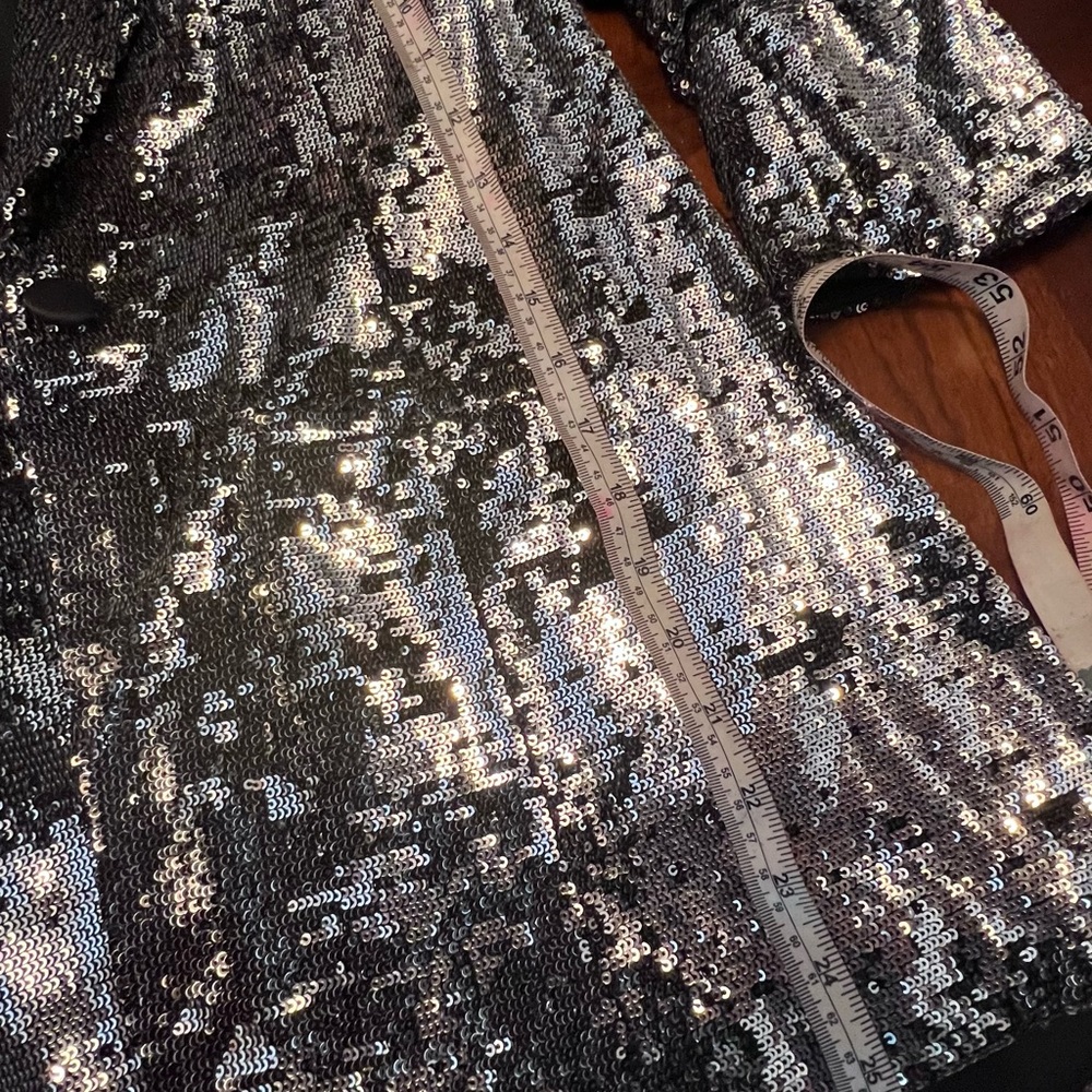 Black blazer with silver sequences. Buttons are all in tact and not itchy.